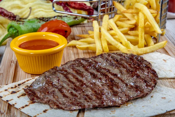 grilled beef steak with french fries and salad