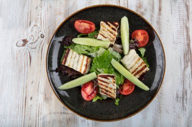 Grilled Halloumi Cheese salad with tomatoes and lettuce. healthy food. clipart