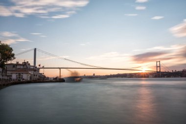 sunset view of the city bridge over Bosphorus, Istanbul, Turkey