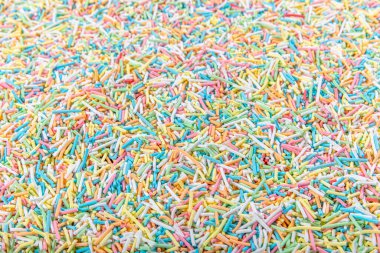 Şeker parçacıkları, pasta ve pasta süslemeleri, arka plan olarak bir sürü serpiştirme.