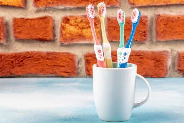 Toothbrushes Ceramic Cup Table Light Background — Stock Photo, Image