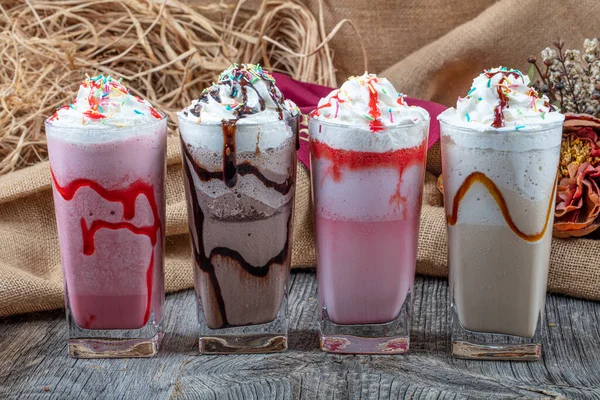 Four Glasses Colorful Milkshake Cocktails Chocolate Milkshake Strawberry Milkshake Caramel — Stock Photo, Image