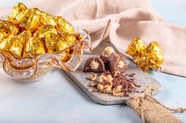 Parlak ambalajda çikolata şekeri. Ahşap arka planda lezzetli çikolata şekerlemeleri. Ramazan Bayramı (Ramazan Bayramı) Konsepti.