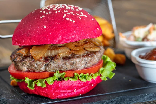 Red bread, burgers. American beefsteak burgers hamburgers pickles, ketchup, mayonnaise and fried potatoes. Trendy food. Restaurant menu concept.