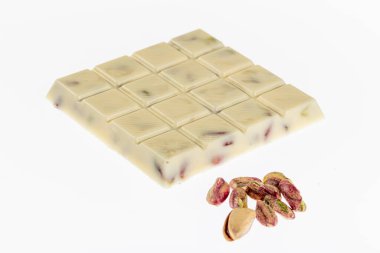 Kırık beyaz çikolata, beyaz arka planda izole edilmiş fıstıklı beyaz çikolata..