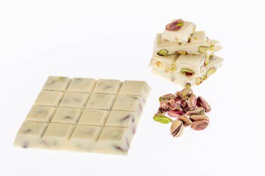 Kırık beyaz çikolata, beyaz arka planda izole edilmiş fıstıklı beyaz çikolata..