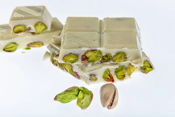 White Chocolate Set Broken chocolate, white chocolate, tablet chocolate and pistachios isolated on white background