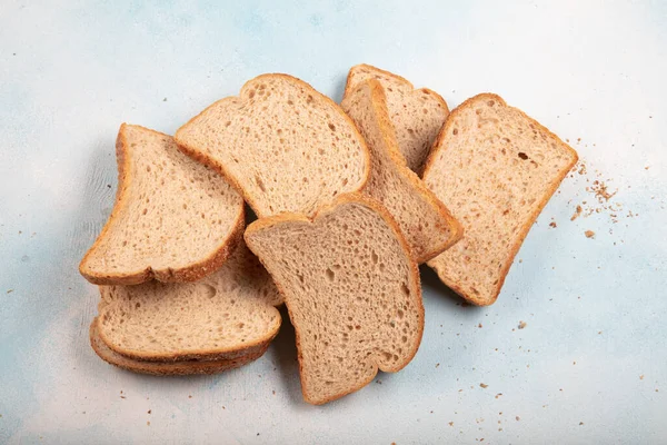 Macrophotography of green mildew on a stale bread. Surface of moldy bread. Spoiled bread with mold. Moldy fungus on rotten bread. Top view