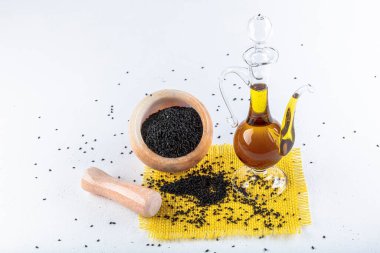 Siyah kimyon tohumları ve kase, tahta kürek ya da kaşık ile gerekli yağ. Nigella Sativa cam şişede. Birçok hastalık için organik bitkisel ilaç.