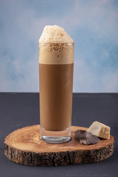 Cold brew or Nitro Coffee drink in the glass with bubble foam. Cold coffee.