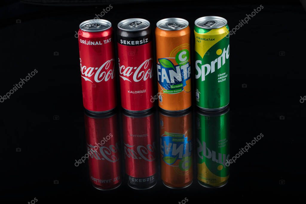 Istanbul, Turkey - August 25, 2020; Aluminum bottles of Fanta, Coca-Cola, Sprite, on a black isolated background.