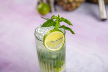 Mojito kokteyli uzun süre içilir geleneksel Küba taze tropikal içecek üst görünüm kopyalama alanı iki viski bardağı, rom, nane, limon suyu, soda ve buz beyaz beton masa üzerinde..