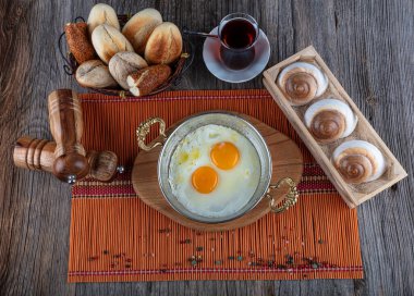 Türk kahvaltısı, bakır tarlasında Türk usulü göz yumurtası. Bakır tavada tereyağı ve yumurta.