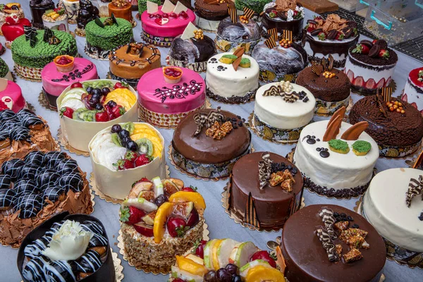 Stock image Pastry shop with selection of cream or fruit cake. Colorful beautiful cakes displayed on the marble countertop.