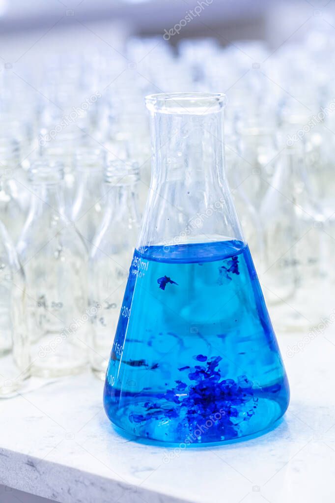 blue solution (methylene blue) in erlenmeyer, experiments in chemistry laboratory.