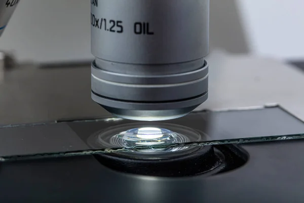 Distribution of immersion oil under light microscope objective lens. Oil immersion is a technique for high resolution light microscopy.