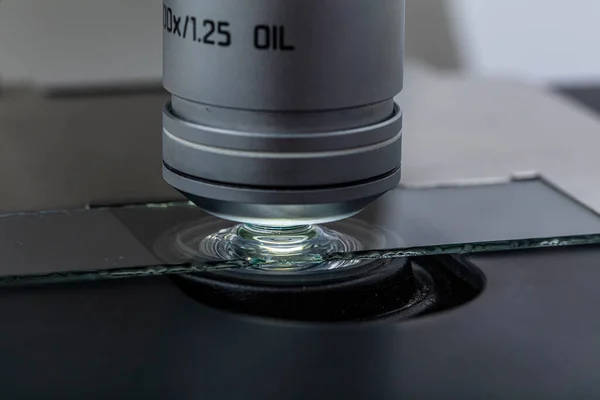 Distribution of immersion oil under light microscope objective lens. Oil immersion is a technique for high resolution light microscopy.