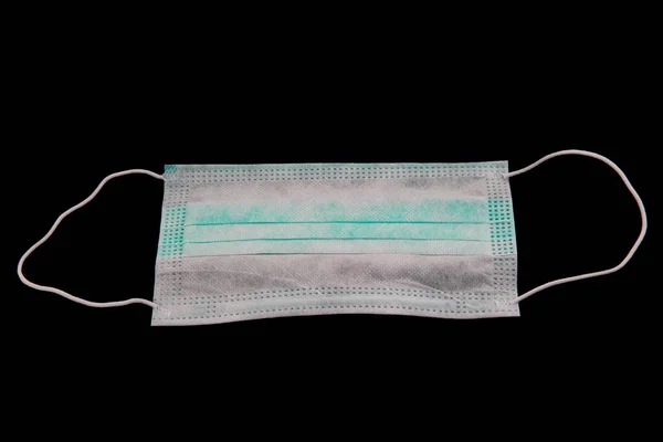 Coronavirus prevention face mask protection. Surgical mask with rubber ear straps. Typical 3-ply surgical mask to cover the mouth and nose. Procedure mask from bacteria. Protection concept.