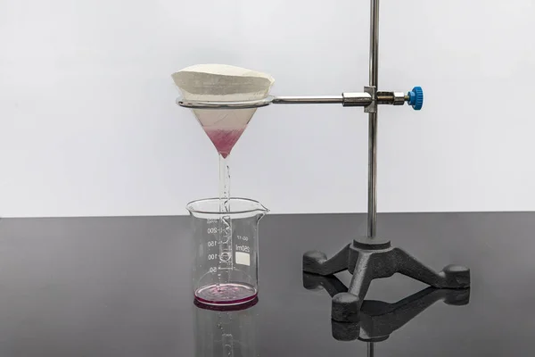 Filter paper in laboratory. Scientists are chemical filtration by filtering through filter paper in a glass funnel, Close up