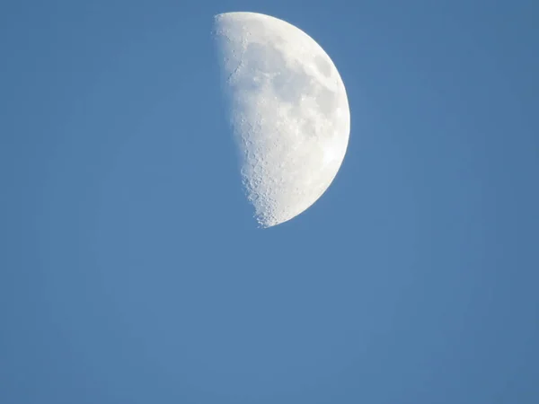 Hold a kék égen. Nagy fehér hold tiszta kék égen, felhők nélkül nappal, napsütéses nappal. — Stock Fotó