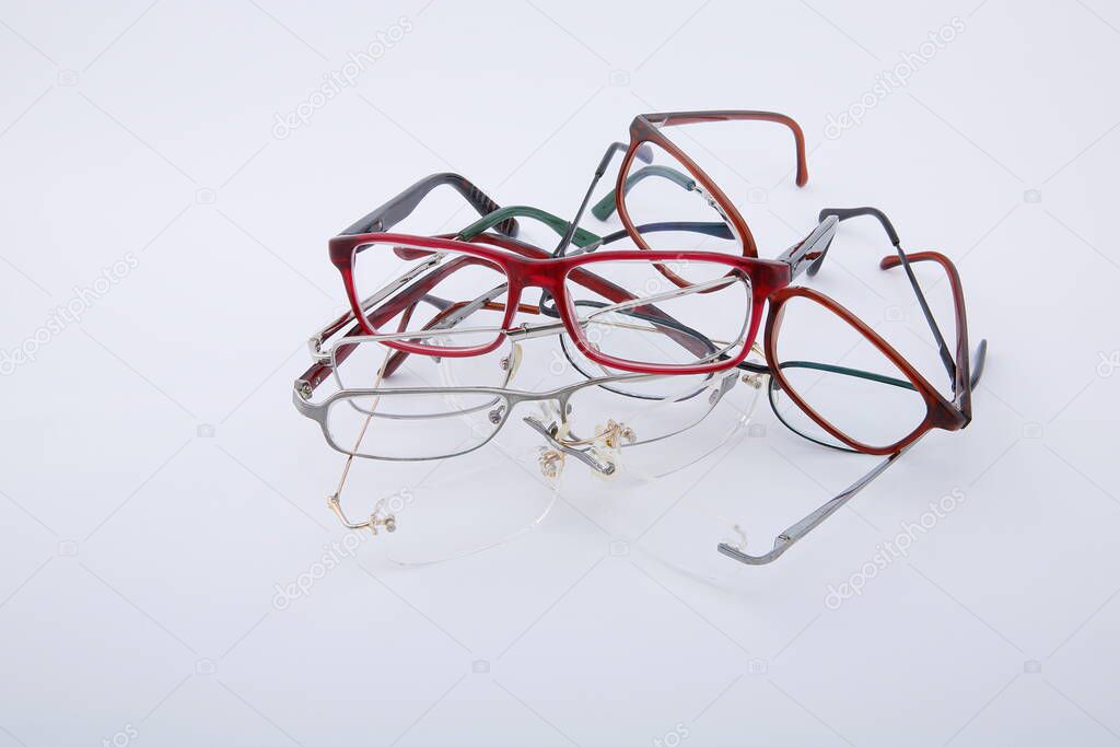 View of used and worn old spectacles on white background.