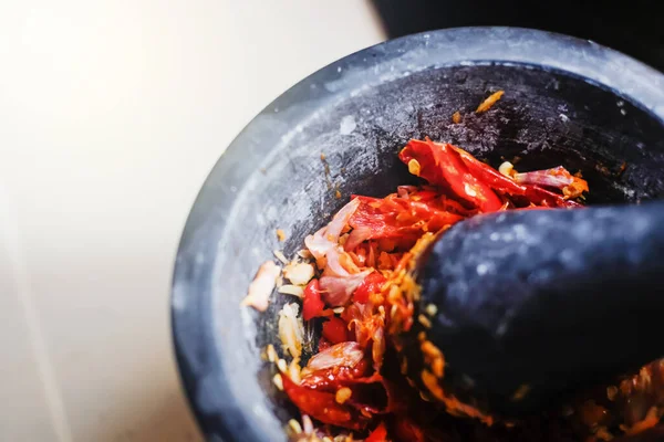 Close up fresh ingredient of Thai food  Red curry paste spicy chili Lemon Grass Shallot and garlic in stone mortar.	