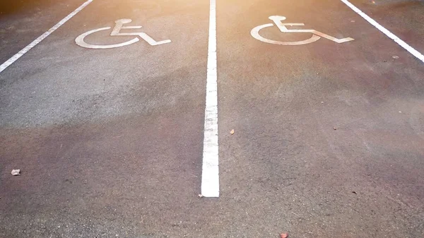 Wheelchair disabled symbol parking permit sign painted on the street lot for handicapped person on concrete road, outdoor place no people, no car , copy space for text.