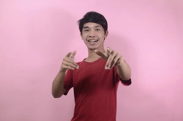 Happy face of funny good looking Asian man. Asian men wearing red t shirts isolated on a pink background