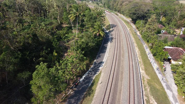 Aerial view of railroad tracks crossing the countryside in Kulonprogo Yogyakarta