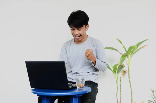 Egy Fiatal Ázsiai Férfi Laptopnál Elégedett Arckifejezéssel — Stock Fotó