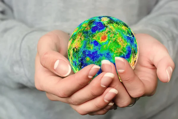 The world is in your hands. A young girl holds the planet Earth in her hands. The concept of the future. Protection of nature and environment. Environmental protection. Image elements provided by NASA