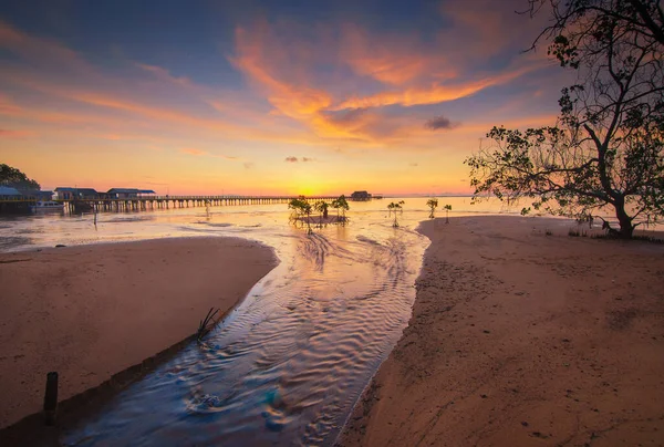 Amazing sunrise at the Sembulang Batam fishing village, the pier  harbor , fishing boats