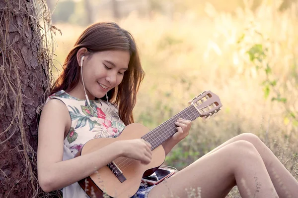 Young Asian Woman Put Earphones Listening Music Playing Acoustic Guitalele — Stock Photo, Image