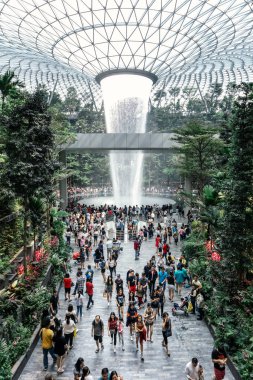 Turistler, 40 metre yüksekliğindeki dünyanın en büyük kapalı şelalesi olan HSBC Yağmur Girdabı 'nı Singapur' daki Changi Havalimanı 'nın yeni turistik merkezi olan Jewel Changi Havalimanı' nda ziyaret ediyorlar.