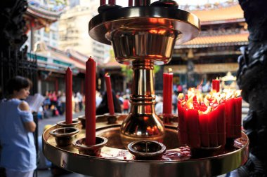 Tayvan 'ın en ünlü tapınağı Longshan Tapınağı' nda yanan kırmızı mumlar sığ bir alan derinliğindedir.