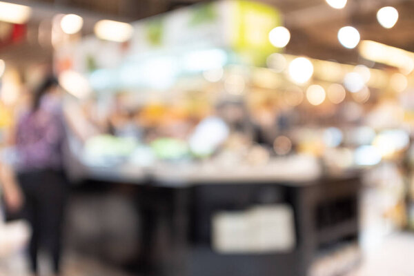 abstract blur and defocused shoppers at salad bar  in modern supermarket for background