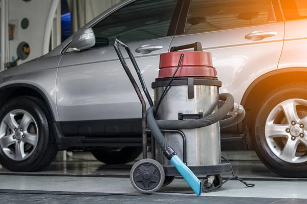 vacuum cleaner at auto washing service station with sunlight effect