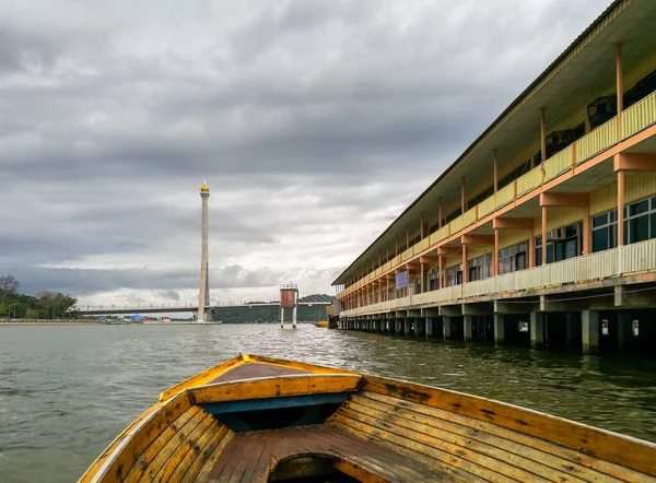 Image of public school at water village at bandar seri begawan brunei from a moving boat. Gloomy rain-bound cloudly background. Focus on school. Noise or grain due to gloomy condition.