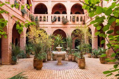 marrakech, morocco. 5th november, 2017: beautiful garden inside moroccan courtyard, marrakech clipart