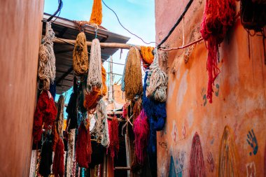 colorful wool hanging at dyers souks, marrakech clipart