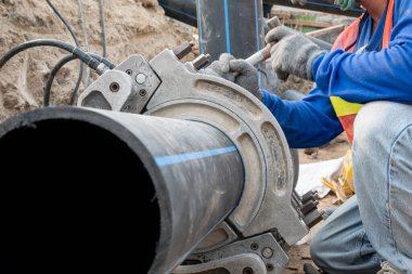 İnşaat alanı su tedarik projesi HDPE borularının bağlanması için çalışıyor 