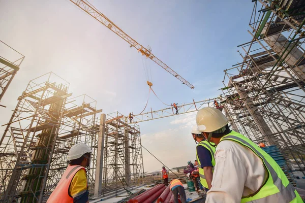 Civil engineer and safety officer inspection construction worker teamwork  election steel truss in construction site