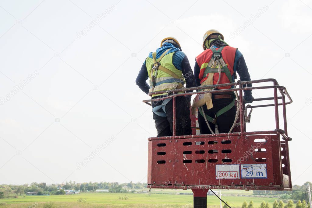  male industry working at high in a boom lift in construction site