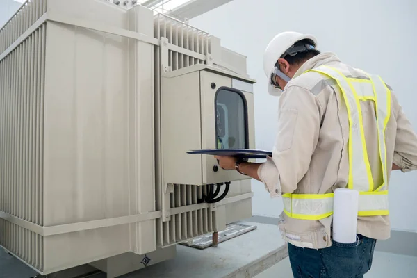 Electric power engineer check electric transformer in construction site