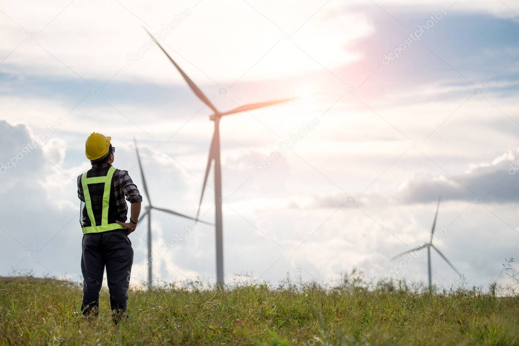 Businessman or electrical engineer checking  on wind turbine energy production energy saving concept 