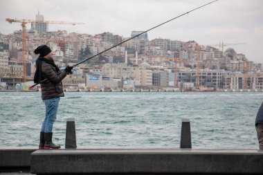 16 Ocak 2020 İstanbul / Türkiye Balıkçısı Eminonu 'da balık tutuyor