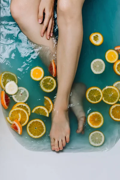 Woman Hand Legs Bath Filled Blue Water Various Cut Citrus — Stock Photo, Image