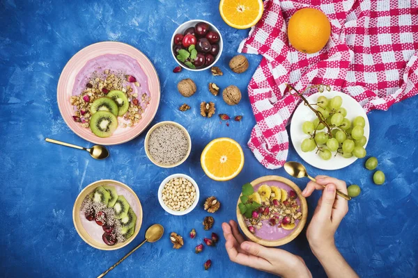 Flatlay with healthy vegan breakfast of berry plant-based yogurt with granola, chia seeds, various fruits and walnuts on blue background — Stock Image Flatlay Healthy Vegan Breakfast Berry Plant Based Yogurt Granola Chia Royalty Free Stock Images