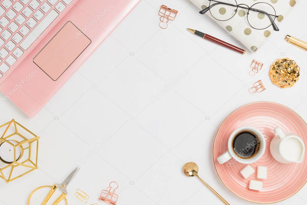 Stylish flatlay frame arrangement with pink laptop, coffee, milk holder, planner, glasses and other accessories. Feminine business mockup, copyspace, white background