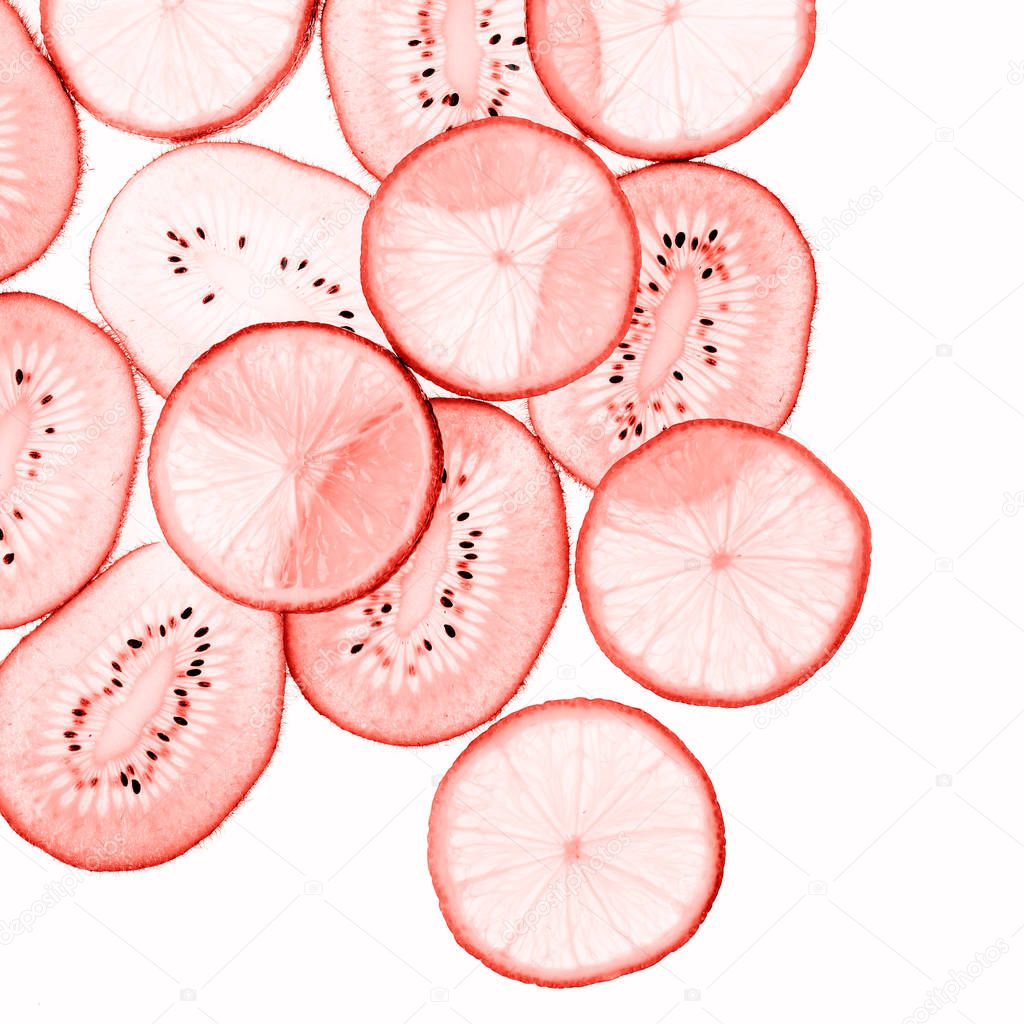 Kiwi and lemon slices toned in living coral color on white background. Color of the year 2019 concept.